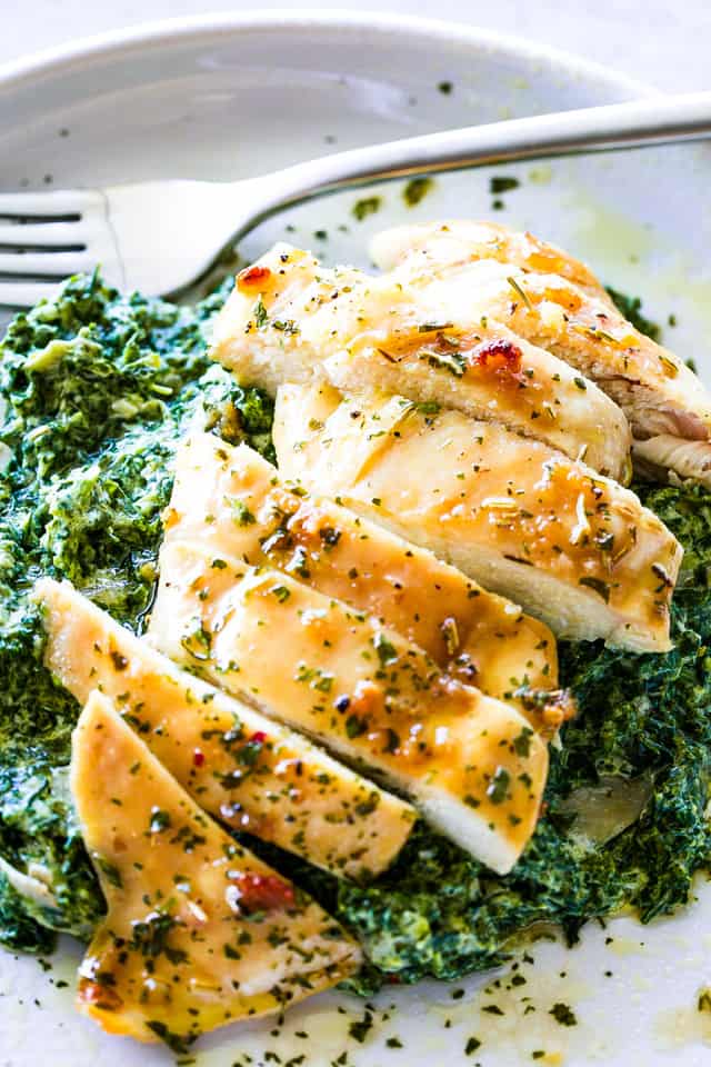 Brown sugar chicken, sliced, and served over creamed spinach.