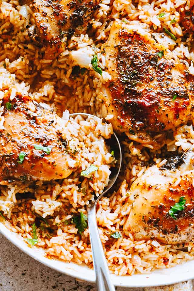 Garlic Butter Chicken and Rice Recipe - Bursting with rich buttery garlic flavor and tender chicken thighs, this is a one pot chicken and rice dinner guaranteed to impress even the pickiest eaters!