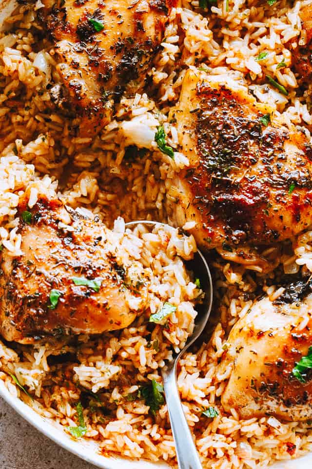 Garlic Butter Chicken and Rice Recipe - Bursting with rich buttery garlic flavor and tender chicken thighs, this is a one pot chicken and rice dinner guaranteed to impress even the pickiest eaters!