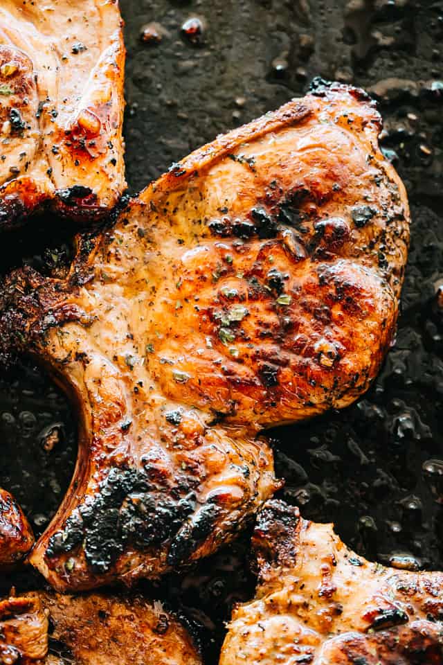 Honey Garlic Baked Pork Chops - Incredibly tender and super juicy pork chops coated in a sticky honey garlic sauce and baked to a delicious perfection. If you're looking for an amazing boneless baked pork chops recipe, this is it!
