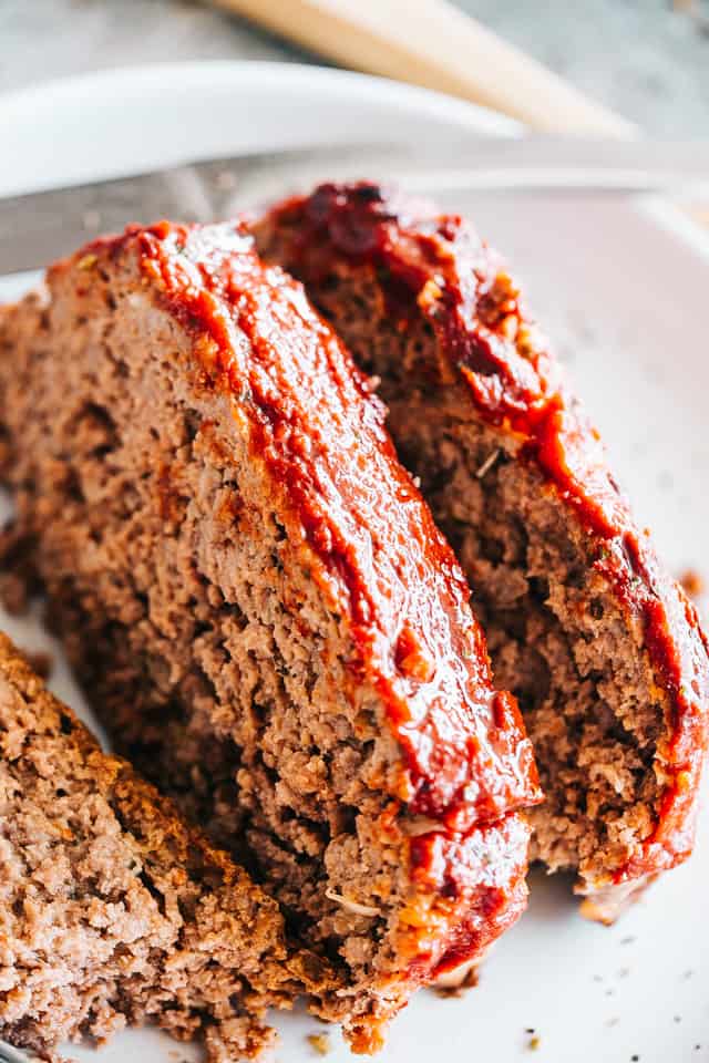 Easy Meatloaf Recipe - Stuffed with feta cheese and topped with a delicious sweet and tangy glaze, this is the absolutely best meatloaf recipe that comes together in just a few quick and easy steps. 