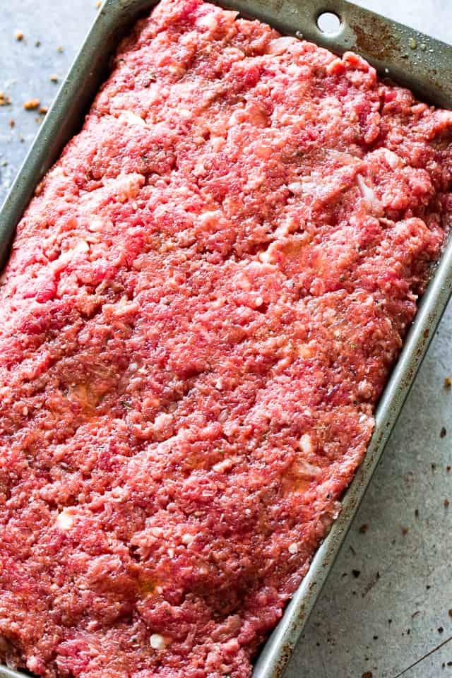 Easy Meatloaf Recipe - Stuffed with feta cheese and topped with a delicious sweet and tangy glaze, this is the absolutely best meatloaf recipe that comes together in just a few quick and easy steps. 