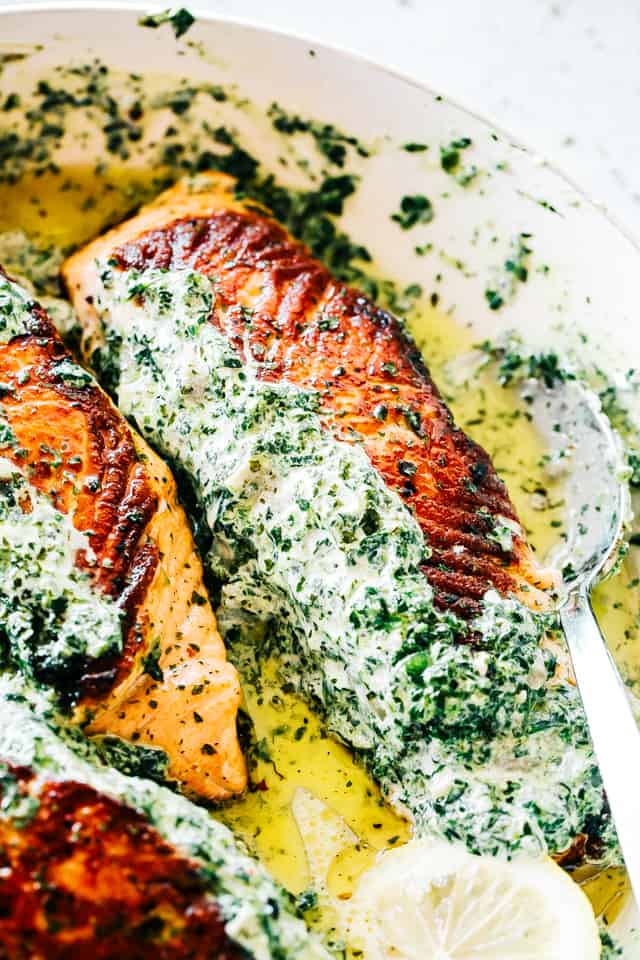 Stuffed Salmon with Spinach and Artichoke Dip - Easy and quick to make, absolutely incredible pan-seared salmon fillets stuffed with a deliciously creamy spinach and artichoke dip.