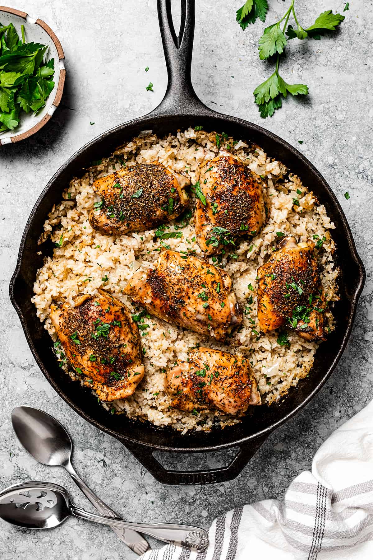 Cooked garlic butter chicken and rice in a skillet.