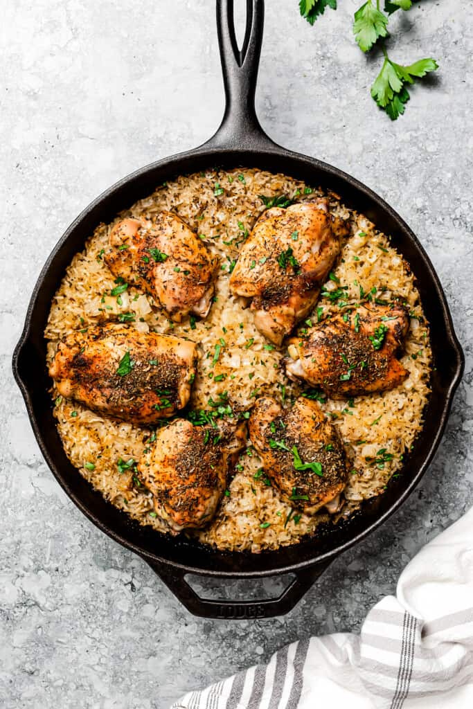 Cooked chicken and rice in a skillet.