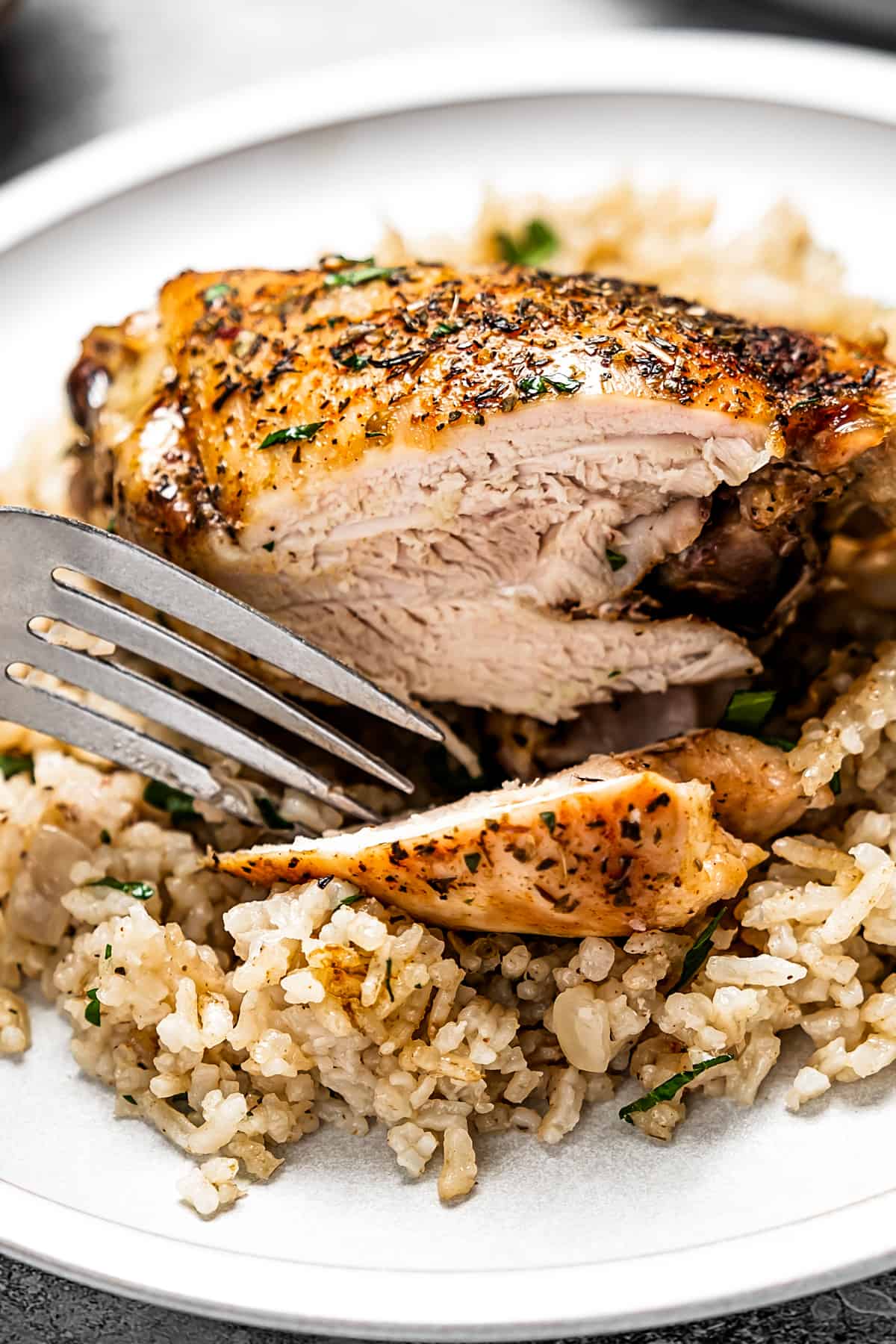 Sliced garlic butter chicken on a plate.