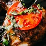 Caprese Pork Chops - Seared juicy caprese pork chops marinated in a garlicky balsamic glaze and topped with sweet tomatoes, melted mozzarella cheese, and fresh basil!