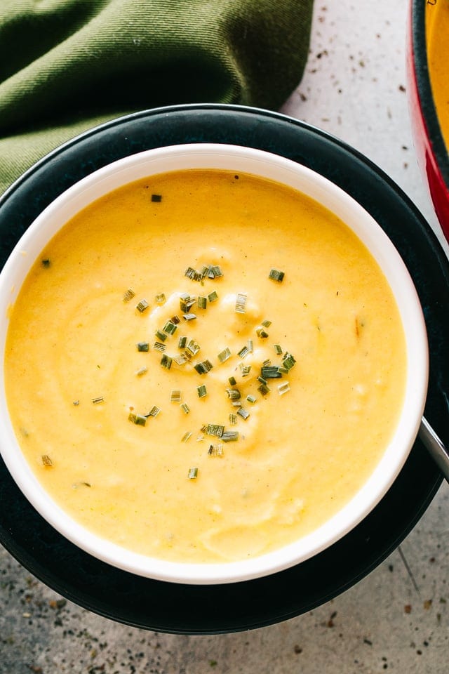 Overhead image of a soup bowl filled with cauliflower cheese soup.