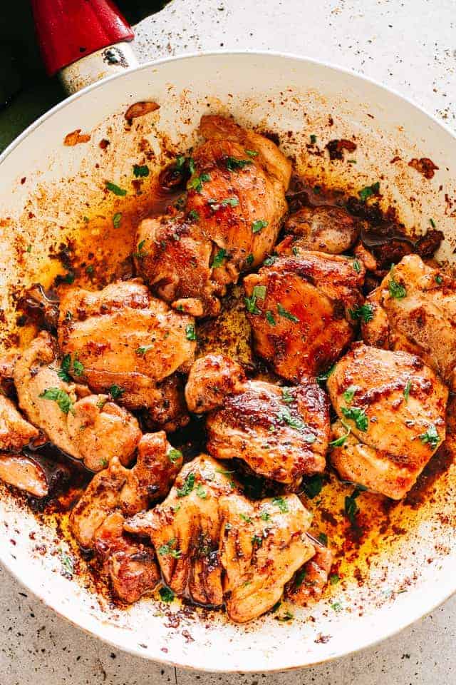 Cook boneless, skinless chicken thighs in a pan.