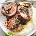 Stuffed Flank Steak Recipe - Tender, juicy, roasted flank steak stuffed with a delicious baby spinach, sun dried tomatoes, and feta cheese filling. A wonderful low carb, keto friendly recipe you don't want to miss! 