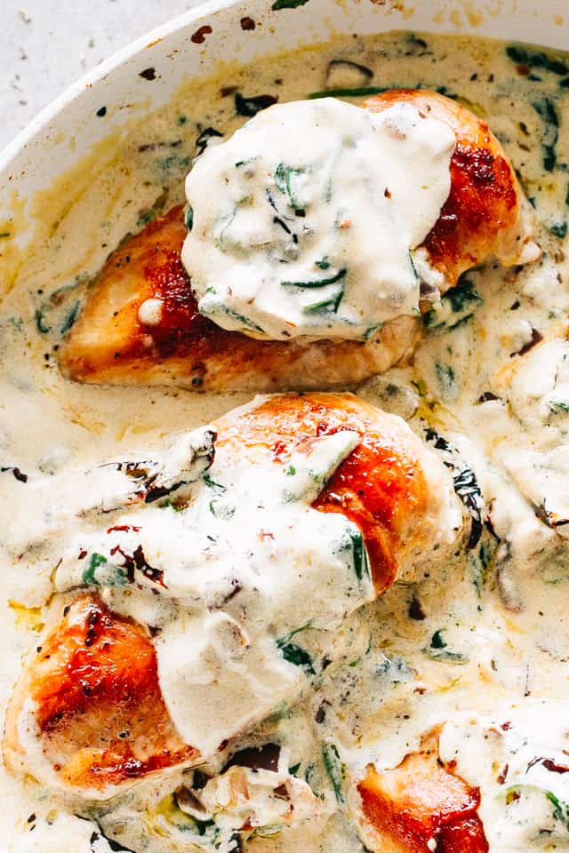 Creamy Tuscan Chicken - One pot, 30-minute dinner made with juicy seared chicken breasts served in a rich and creamy sauce chock full of sun-dried tomatoes, dried herbs, and fresh spinach.