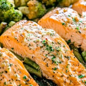 Garlic Butter Baked Salmon - Tender and juicy salmon brushed with an incredible garlic butter sauce and baked on a sheet pan with your favorite veggies. This delicious baked salmon takes just a few minutes of prep and makes for a perfect weeknight meal in just 30 minutes.