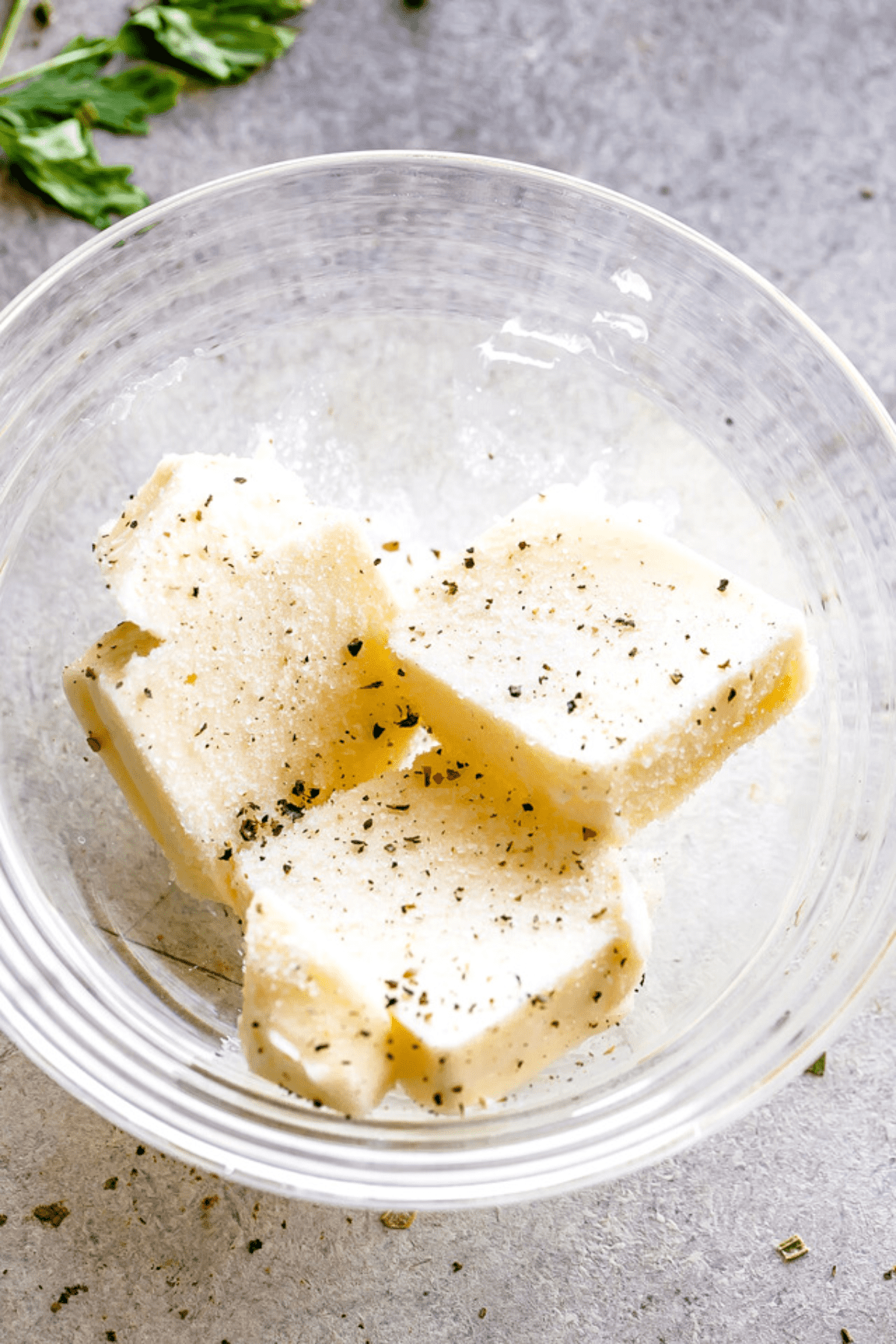 three pats of butter in a small glass bowl.