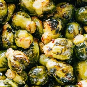 Close up view of oven roasted Brussels sprouts tossed in honey balsamic glaze.