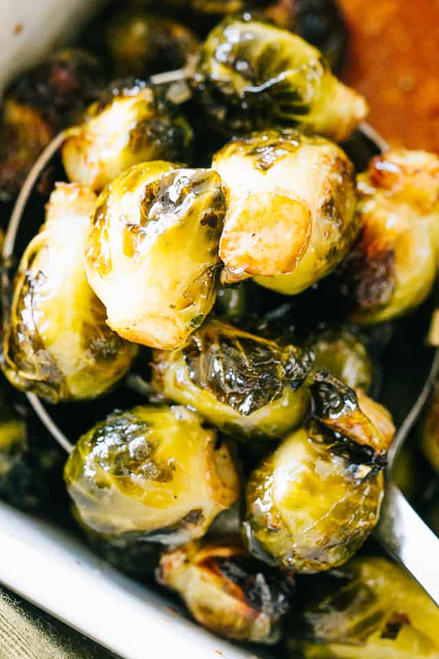 Overhead view of a serving spoonful of oven roasted Brussels sprouts.