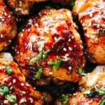 Close up-photo of Instant Pot Sticky Chicken Thighs garnished with sesame seeds and cilantro.