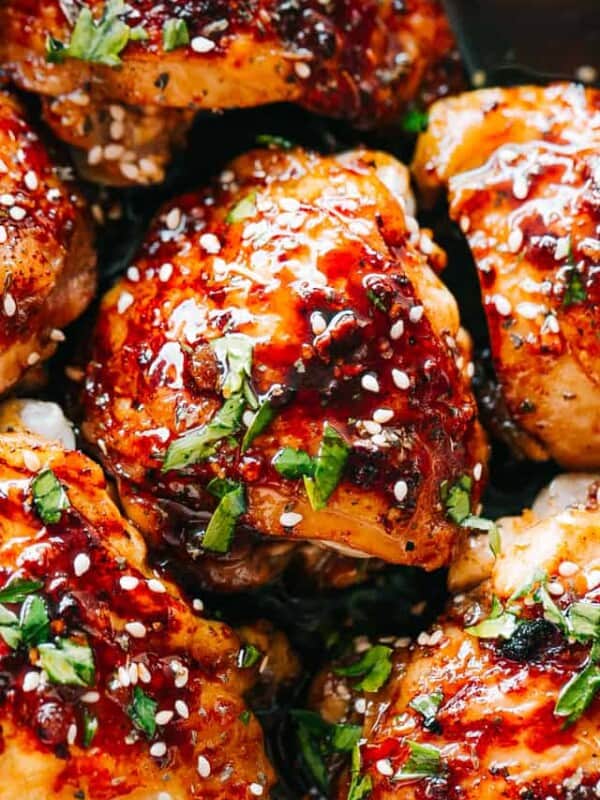 Close up-photo of Instant Pot Sticky Chicken Thighs garnished with sesame seeds and cilantro.