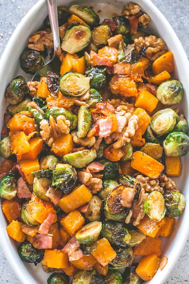 Overhead view of Roasted Butternut Squash with Brussels Sprouts in an oval dish.