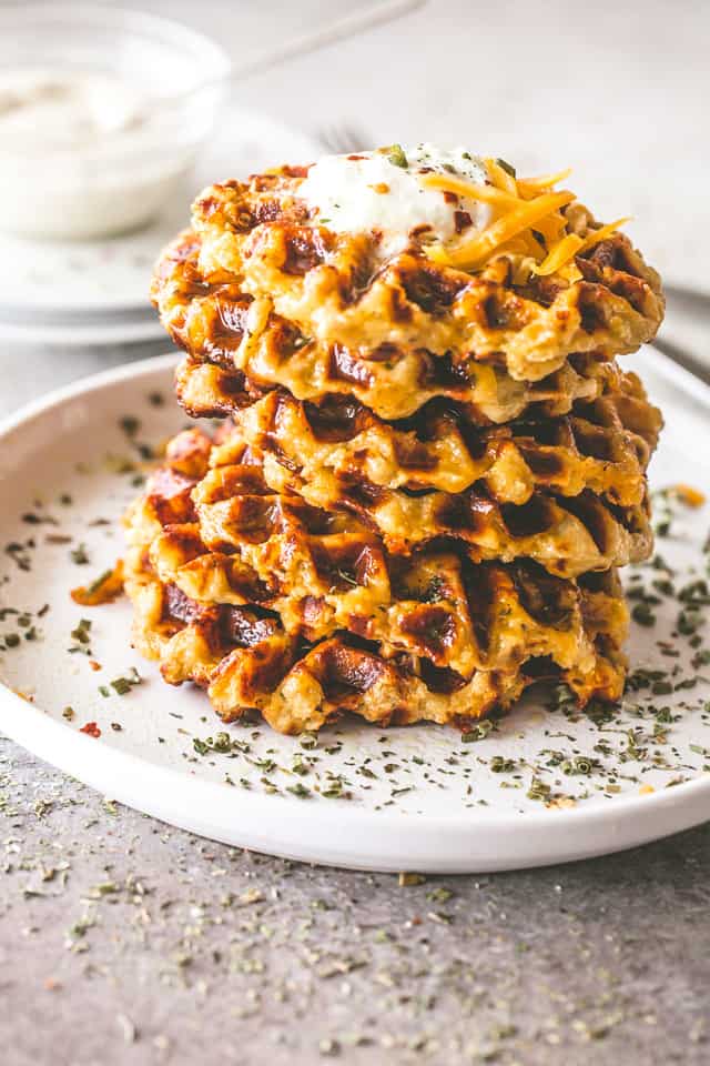Cheesy Potato Waffles - Delicious, cheesy, and savory waffles prepared with leftover mashed potatoes and cheddar cheese. Crispy on the outside and fluffy on the inside, these potato waffles not only taste amazing, but they are a super fun meal to serve to your family. 