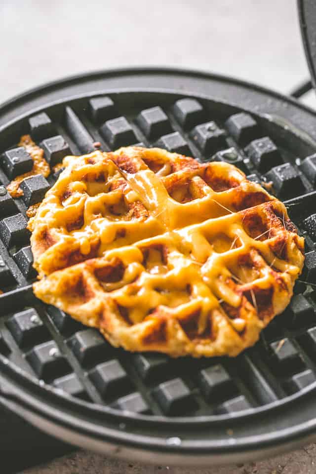 Cheesy Potato Waffles - Delicious, cheesy, and savory waffles prepared with leftover mashed potatoes and cheddar cheese. Crispy on the outside and fluffy on the inside, these potato waffles not only taste amazing, but they are a super fun meal to serve to your family. 