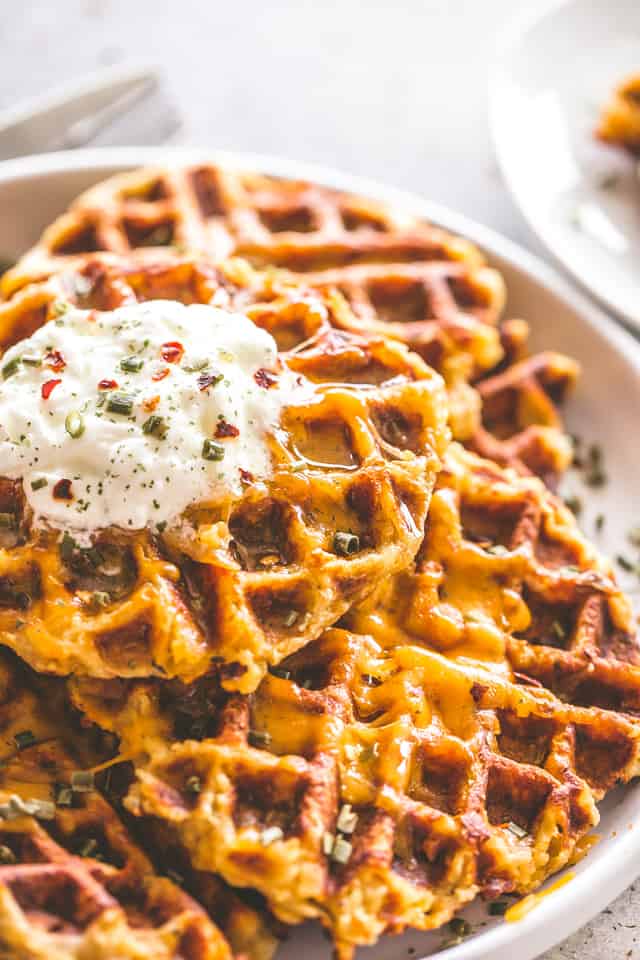 Cheesy Potato Waffles - Delicious, cheesy, and savory waffles prepared with leftover mashed potatoes and cheddar cheese. Crispy on the outside and fluffy on the inside, these potato waffles not only taste amazing, but they are a super fun meal to serve to your family. 