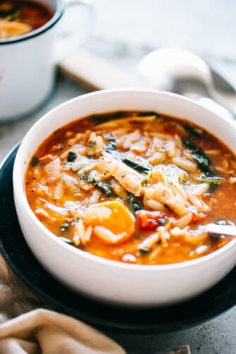 A bowl of leftover turkey soup with orzo and spinach.