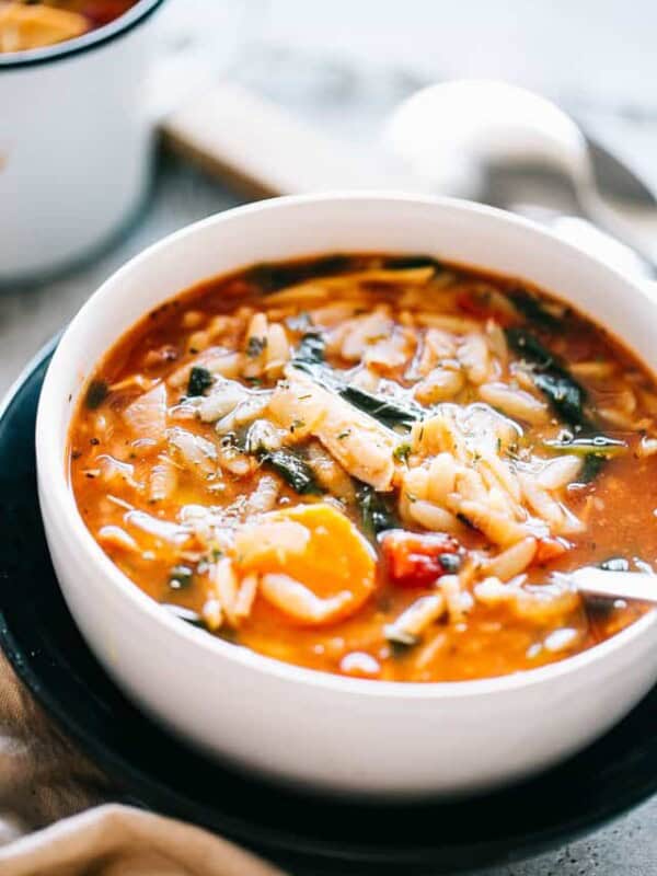 A bowl of leftover turkey soup with orzo and spinach.