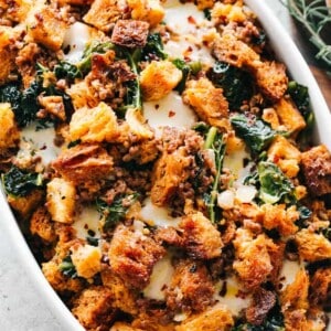 Cheesy Italian Sausage Stuffing Recipe - An incredible Thanksgiving stuffing prepared with Italian sausage, kale, and provolone cheese! A wonderful combination of savory, hearty, and cheesy, all in one bite. 