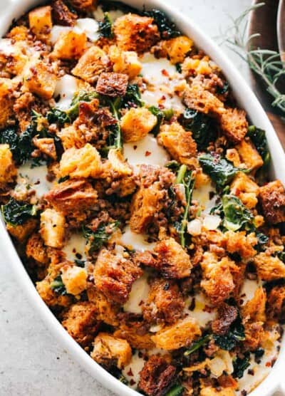 Overhead image of cheesy sausage stuffing in a casserole dish.