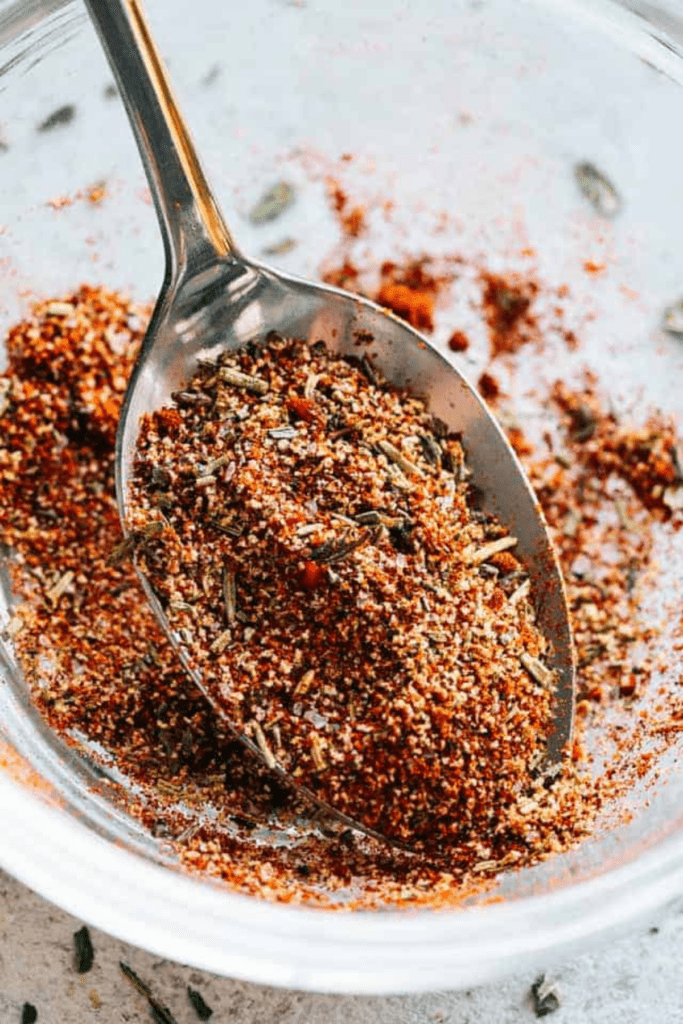 close up of a tablespoon spooning out a homemade chicken #seasoning blend.