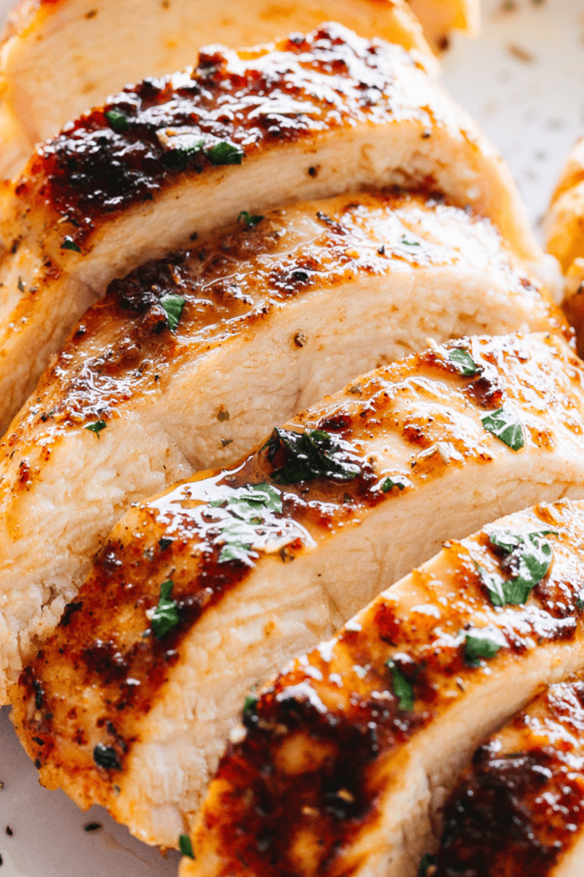 close-up shot of a chicken breast cut into horizontal slices.