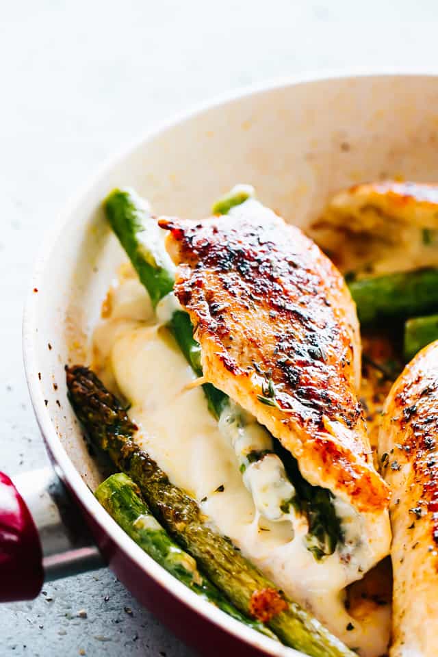 Cheesy Asparagus Stuffed Chicken Breast in a skillet.