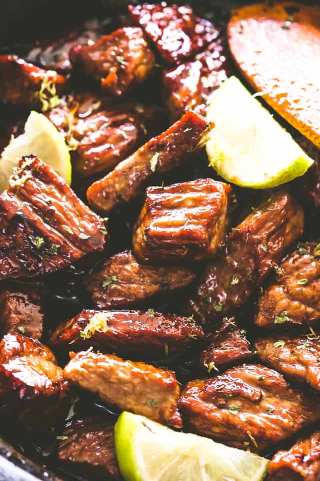 Stirring Chili Lime Steak Bites while cooking them in a cast iron skillet.