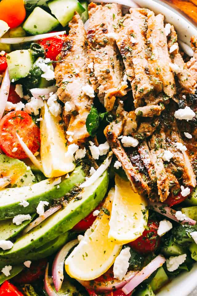 Close up shot of a Steak Salad tossed with feta cheese, tomatoes, and avocados.