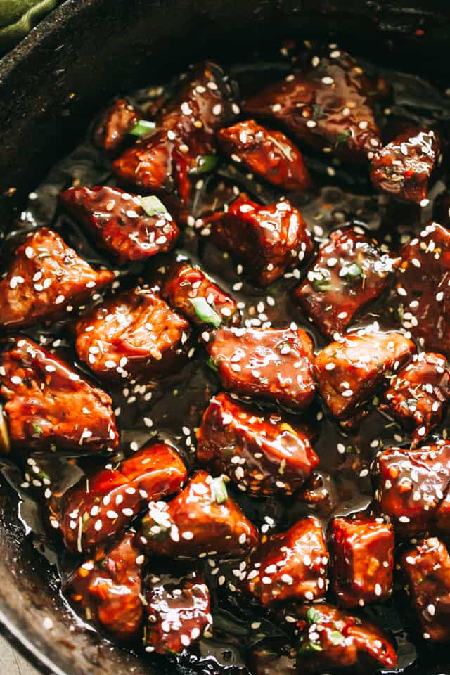 Steak Bites cooking in a skillet.