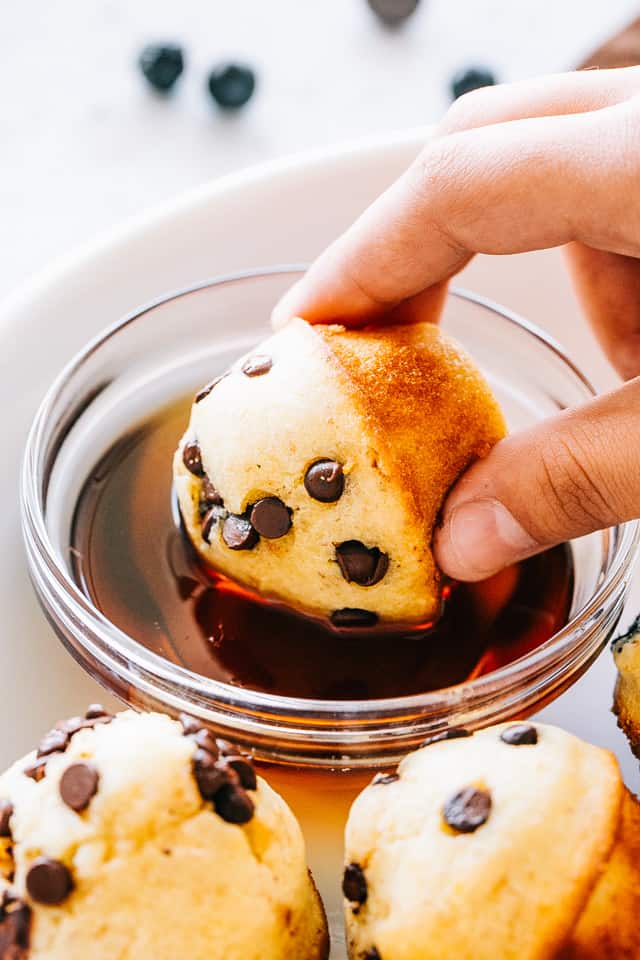 Dipping a pancake bite into maple syrup.