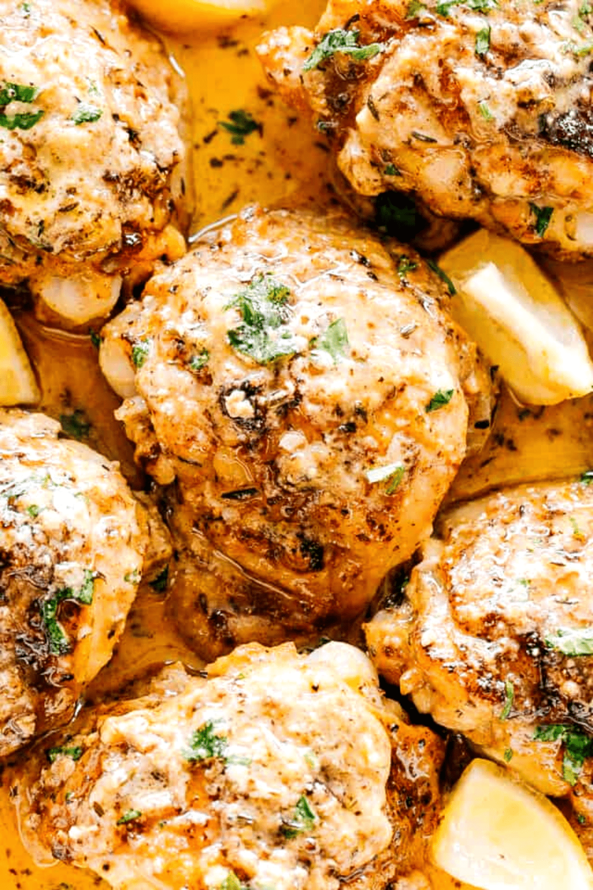 close up shot of chicken thighs cooked in the instant pot with lemon butter sauce.