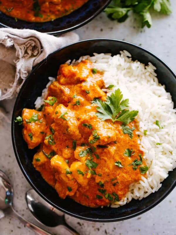 A bowl of Indian Butter Chicken served over rice.