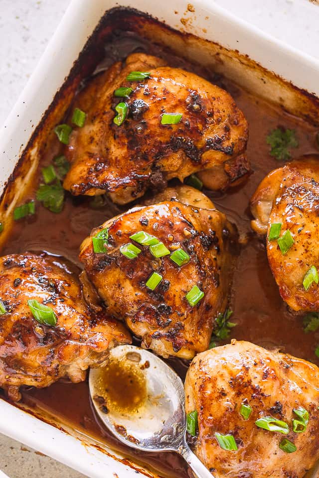 These juicy oven baked chicken thighs make for an easy, simple dinner. Marinated in a sweet soy sauce, you'll love this delicious baked chicken recipe! Baked Chicken Thighs in a pan