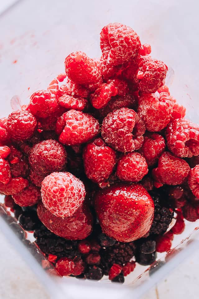 Frozen Berries inside the jar of a blender.