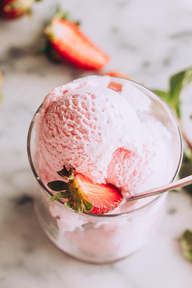 2 ingredient Ice Cream served in a glass cup and topped with halved strawberries