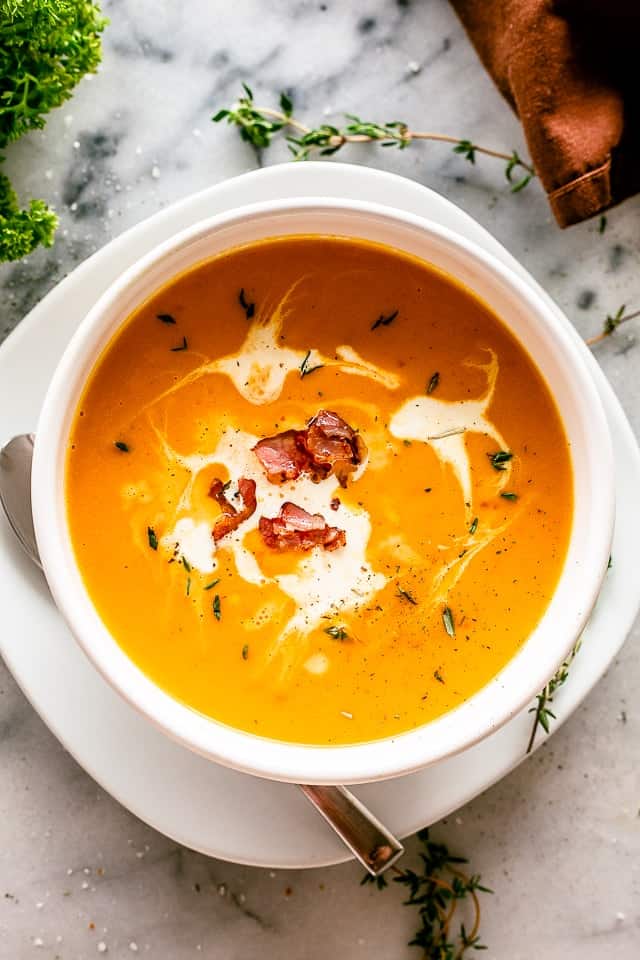 Overhead shot of a bowl with soup and a garnish of heavy cream.