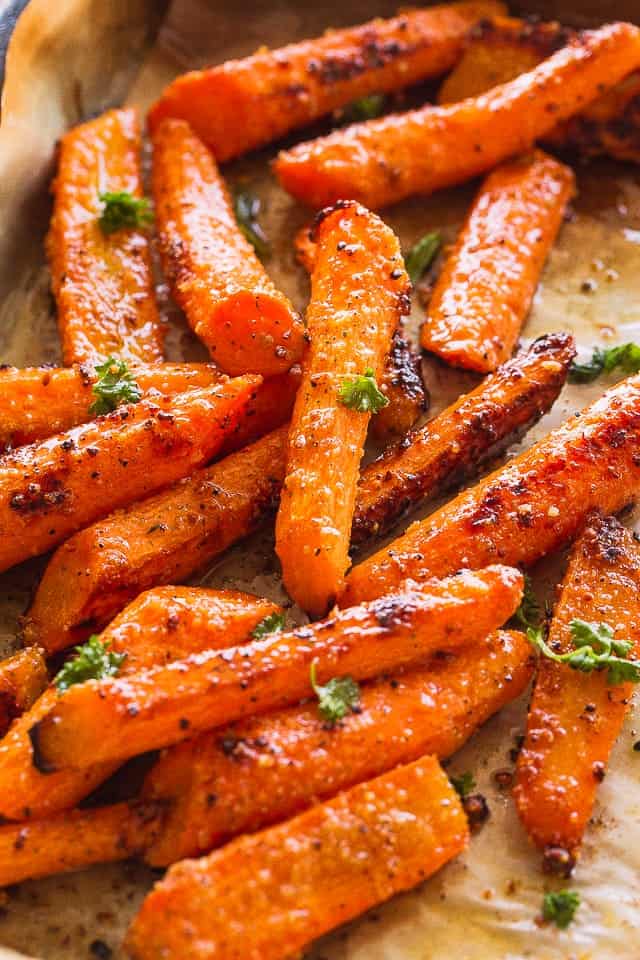 Roasting Carrots on a parchment-lined baking sheet.