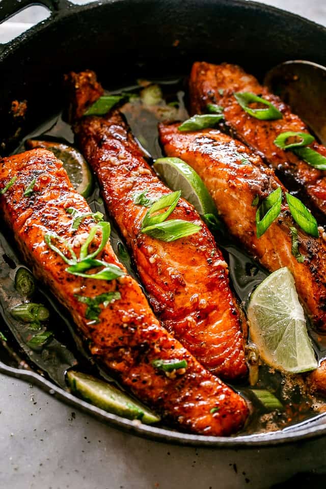 Honey Garlic Salmon Fillets in a cast iron skillet. 