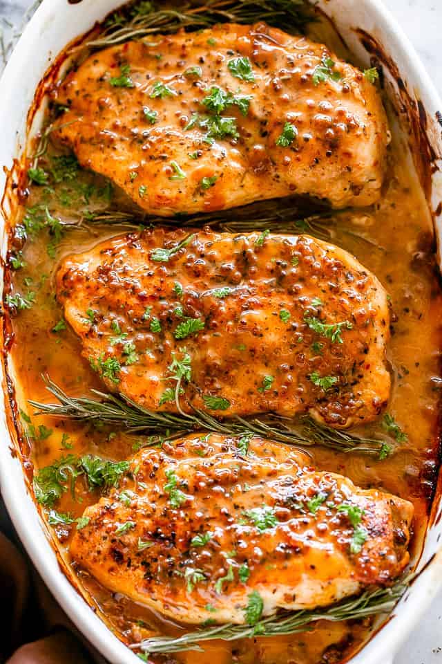 overhead shot of a baking dish with three Baked Honey Mustard Chicken breasts.