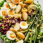 Spring salad with eggs, asparagus, potatoes, and beans.