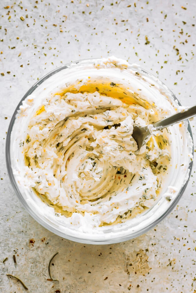 mixing Ranch and Cream Cheese in a glass bowl