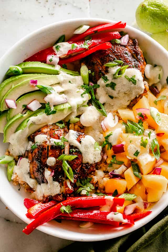 Cajun Chicken Cauliflower Rice in Bowls with Avocado and Mango