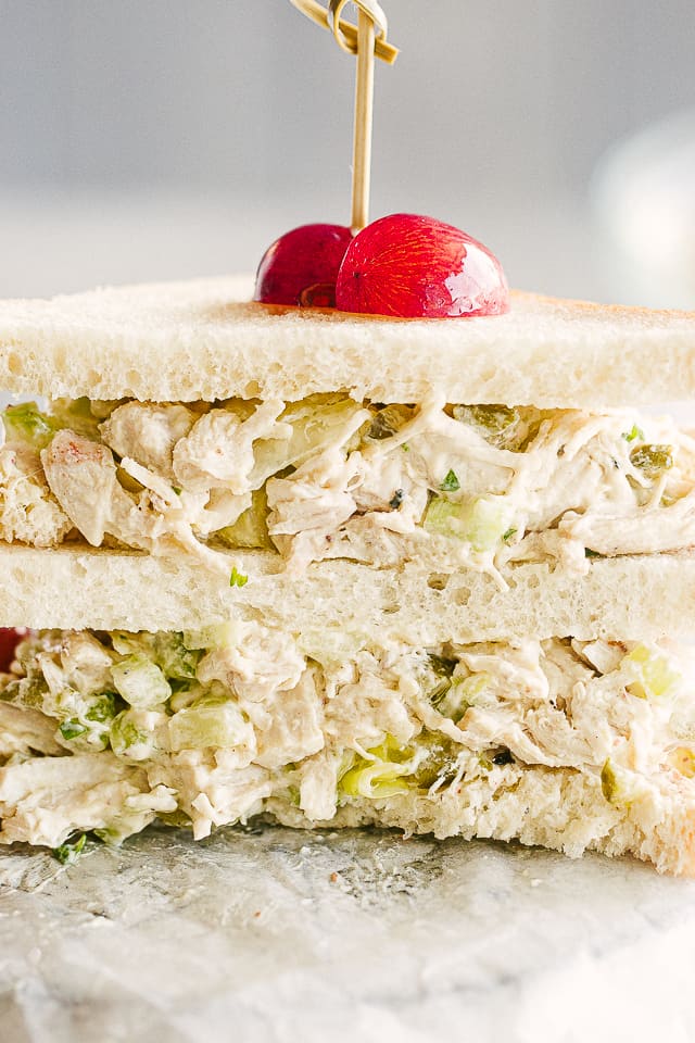 Chicken Salad Sandwiches cut in half and stacked one on top of the other. 