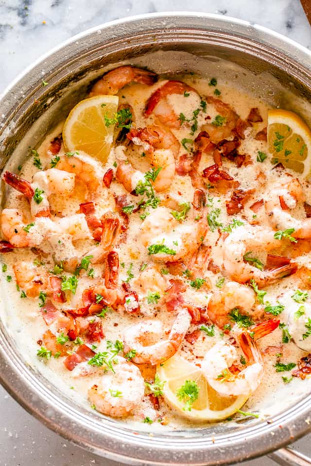 Overhead image of Garlic Shrimp and diced bacon cooked in a skillet. 